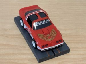 Tomy AFX Pontiac Firebird rot mit Bulldog-Chassis